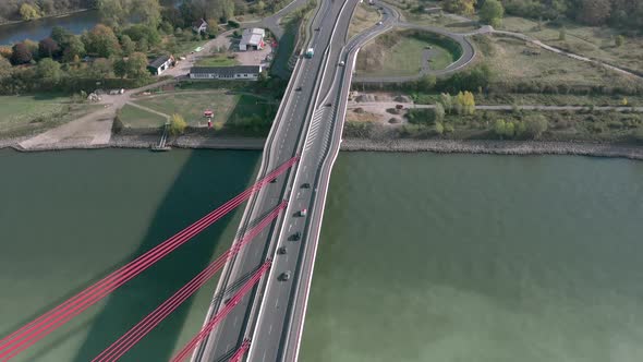 Vehicles Crossing a Cable Stayed Suspension Bridge Crossing a River