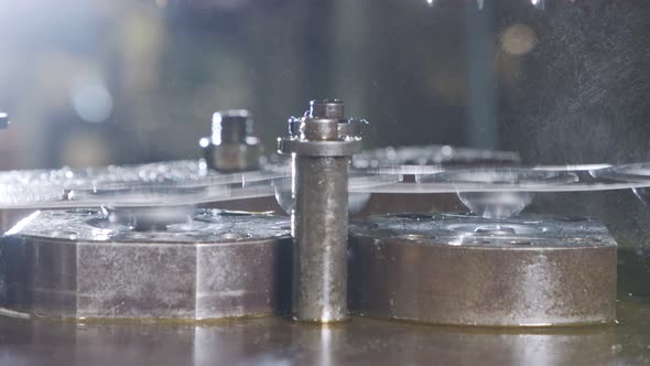 Close up of a punch press forming metal parts in a production line