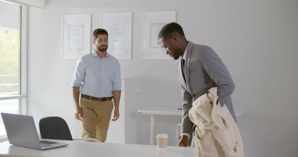 Diverse Business Colleagues Greeting and Shaking Hands in Modern Office