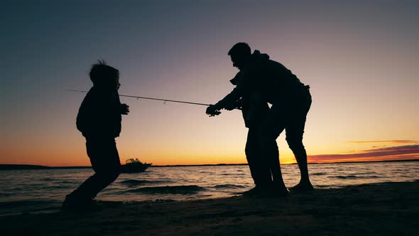 Father Is Teaching His Happy Kids To Catch Fish