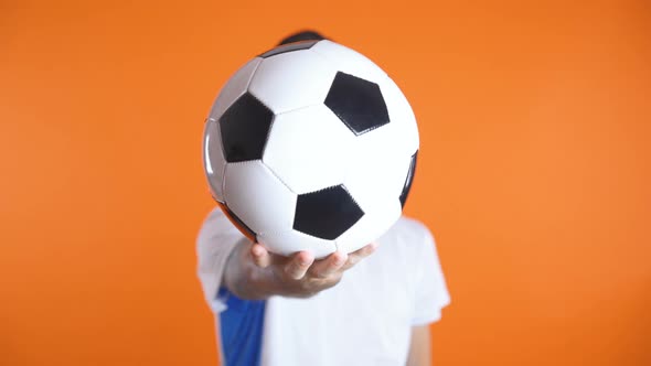 Tatooed Football Fan or Player with Ball Infont of His Face