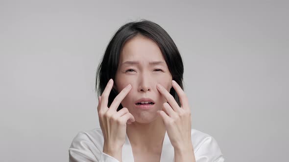 Korean Mature Woman Touching Face Making Facial Massage Gray Background