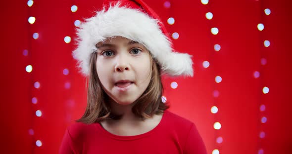 Cute Girl Sings a Carol on Red Christmas Background