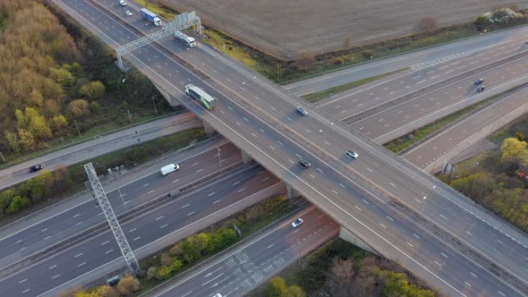 Vehicles Driving on a Motorway at Sunset Using The Junction and Bridges