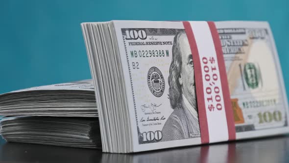 Bundles of Dollars Rotate on Blue Background Heap of Money