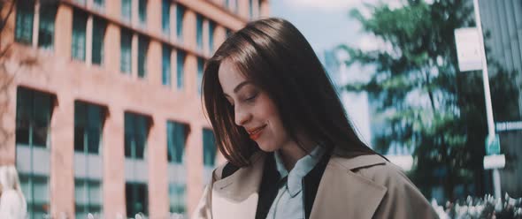 Woman adjusts hair while texting with other hand