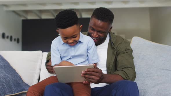 African american father and son using a digital tablet together