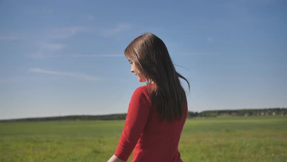 A Girl Launches a Toy Paralon Airplane Into the Sky