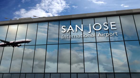 Airplane landing at San Jose California, Costa Rica airport mirrored in terminal