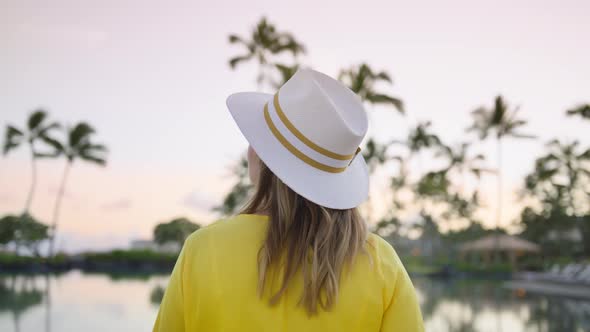 Tourist Woman in Straw Hat Enjoying Summer Vacation at Sea Beach Scenic Sunset