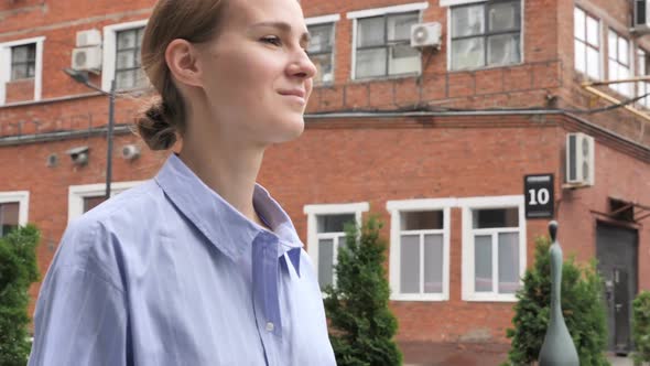 Slow Motion of Young Woman Walking on Street