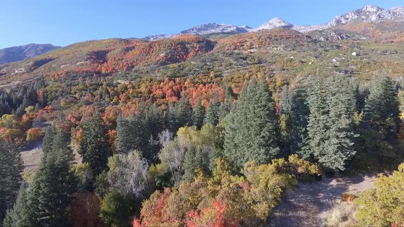 A drone flies near the rocks and slopes of the mountain near Dry Creek Trailhead in Alpine, Utah as