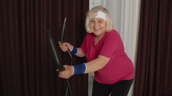 Senior Woman in Sportswear Using Orbitrek in Room at Home Doing Sport Training Cardio Exercises