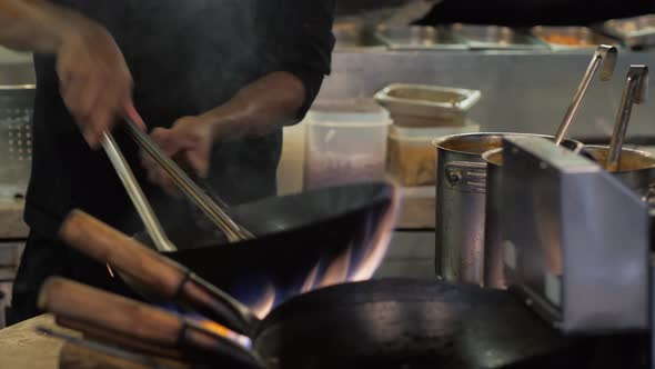 Chef is Stirring Vegetables in Wok Noodles Fire Flambe Asia Kitchen Chinesse Pan Pasta Seafood