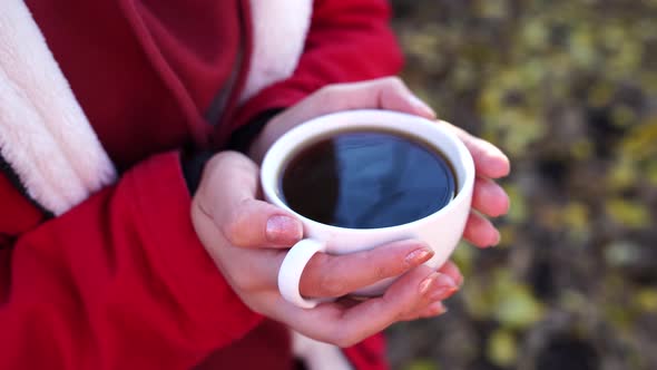 Close Up of Cup of Coffee in Woman's Hands