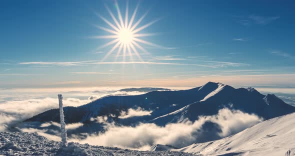 Sunny Panorama of Winter Alps Mountains Nature with Fast Misty Clouds