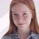 Happy Ginger Teenage Girl with Freckles Smiling Against White Wall - VideoHive Item for Sale
