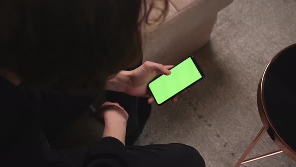 Man at Home Lying on a Couch using Smartphone 