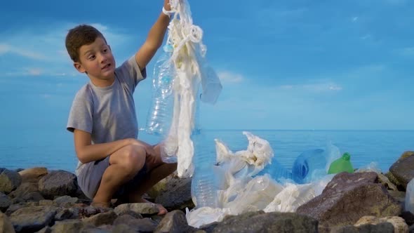 Little Child Volunteer Cleaning Up the Beach at the Sea. Safe Ecology Concept