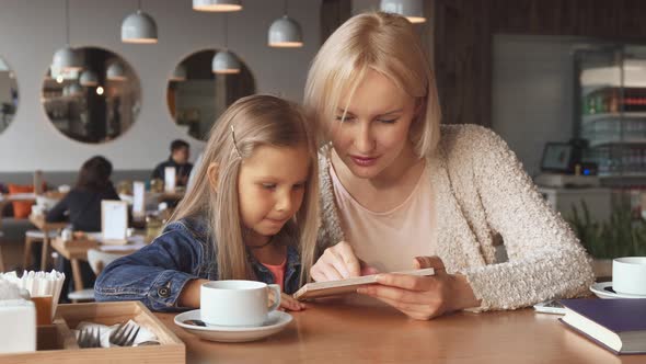 Mother and Daughter Look at the Menu