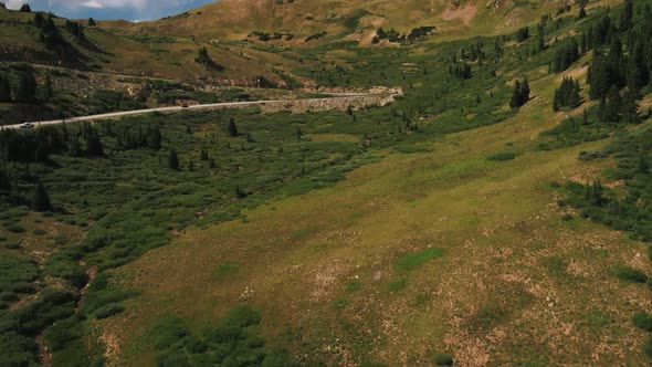 Colorado Mountains Aerial Tilt Up View of Alpine Meadow With Rocky Mountains in Background