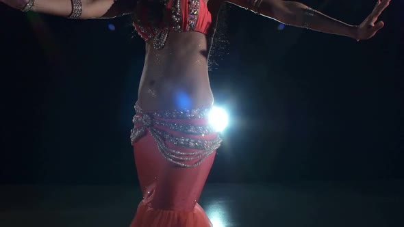 Torso of a Beautiful Young Girl Belly Dancer on a Black, Back Light, Cam Moves Down