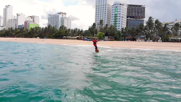 Athlete Showing Sport Trick Jumping with Kite and Board in Air. Extreme Water Sport and Summer