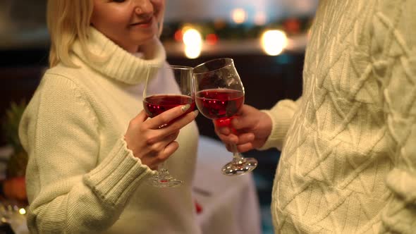 Happy Unrecognizable Caucasian Couple Toasting Drinking Red Wine Standing in Kitchen at Home