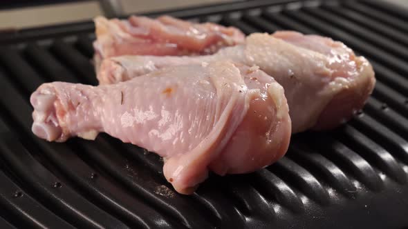 Pieces of Chicken are Put in an Electric Grill to Fry