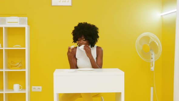 Black Woman Is Eating Tasty Pizza In Yellow Room