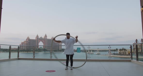 Gorgeous View on Atlantis Hotel in the Background of Wheel Gymnast Performing