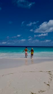 Anse Georgette Praslin Seychelles Young Couple Men and Woman on a Tropical Beach During a Luxury