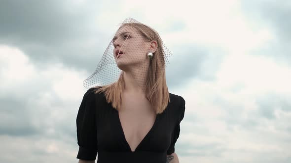 Flamboyant Girl In Black Dress Goes By The Field.