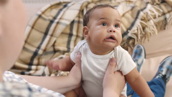 Caucasian Mother Holding Adopted Child and Playing.