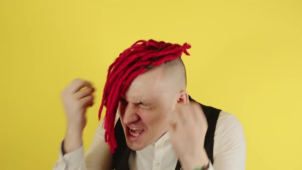 Young Man with Red Dreadlocks Shouts Gesturing with Hands