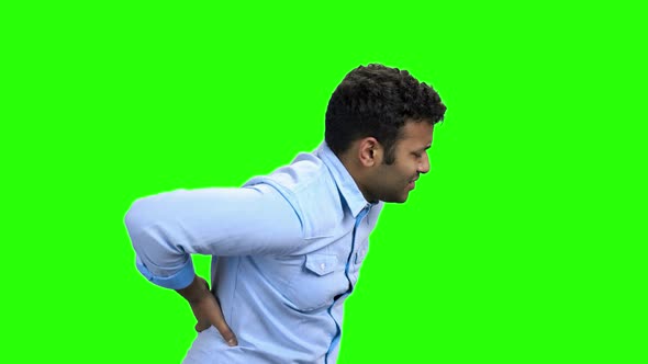 Young Man with Pain in Kidneys on Green Screen