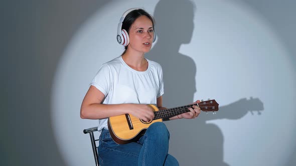 Singing Girl with Ukulele. Little Guitar