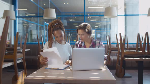 Young Female Cafe Owners Discussing Plan of Business Development After Closing Cafe