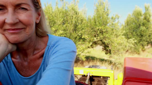 Portrait of happy woman sitting in tractor 4k