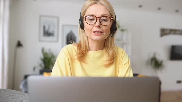 Middleaged Woman Wearing Headset Talking on the Distance