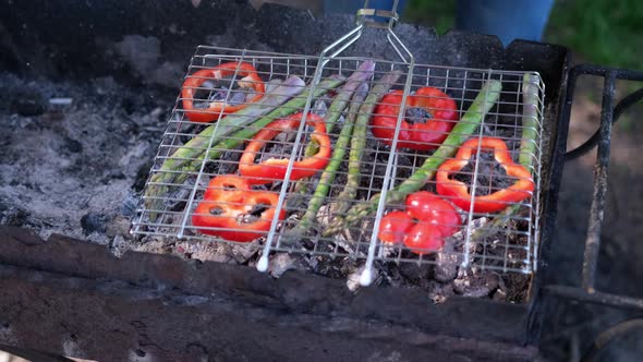 Making Grilled Vegetables  Asparagus and Red Pepper on a Charcoal Grill