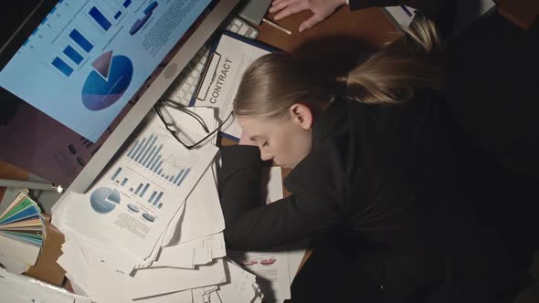 Female Office Worker Sleeping on Desk