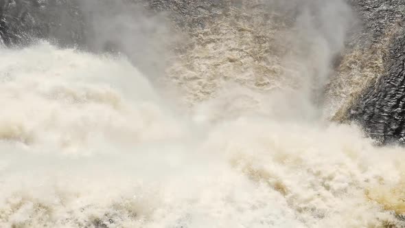 Looking Down On A Very Big Waterfall As The Water Rushes To The Bottom Lake