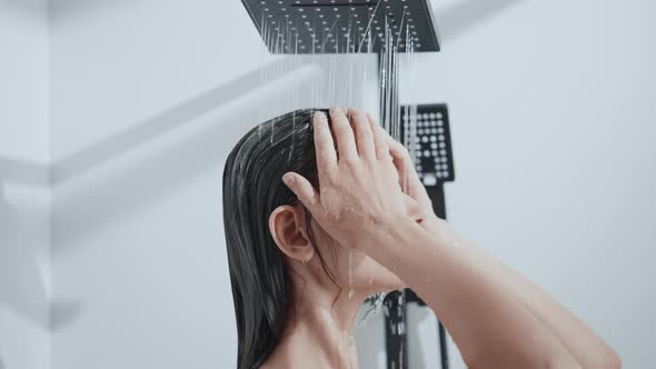 Young Woman Showering with Closed Eyes