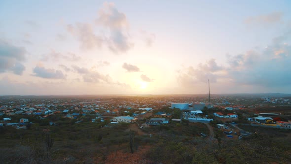 Pink glowing sunrise over Curacao cityscape on summer morning