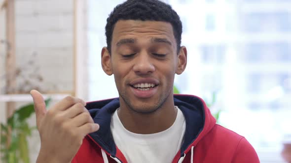 Portrait of AfroAmerican Man Inviting Customers with Both Hands