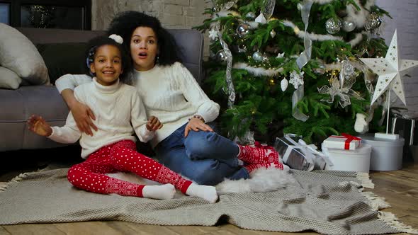 Portrait of African American Mom and Her Little Daughter with Shocked and Surprised Wow Face