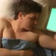 A caucasian young man sleeps and holds a tablet PC in hand (green screen) - VideoHive Item for Sale