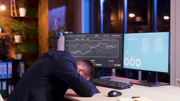 Tired Businessman Resting His Head During Night Hours at the Office