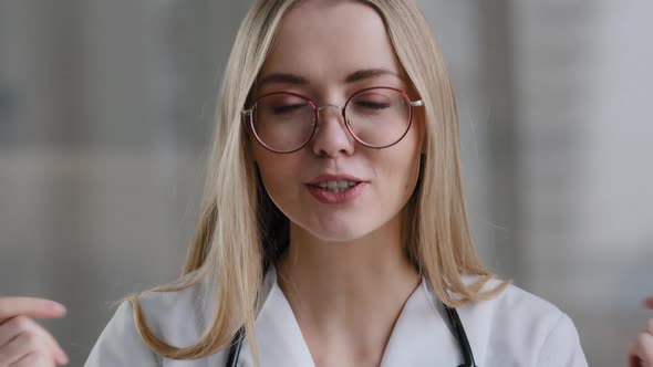 Caucasian Female Doctor Wear Eyeglasses Make Online Video Call in Hospital Clinic Consult Patient